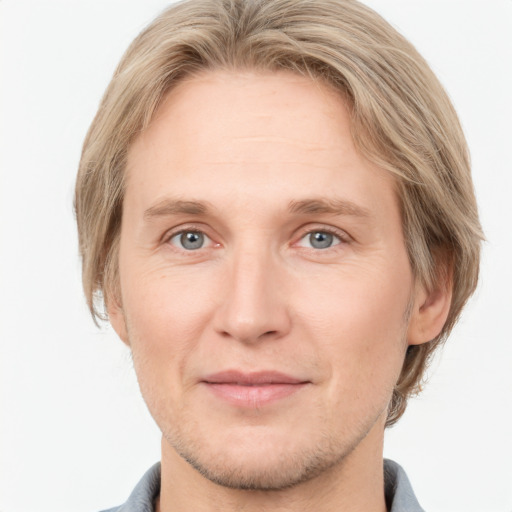 Joyful white adult male with short  brown hair and grey eyes