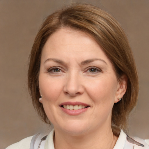 Joyful white adult female with medium  brown hair and brown eyes