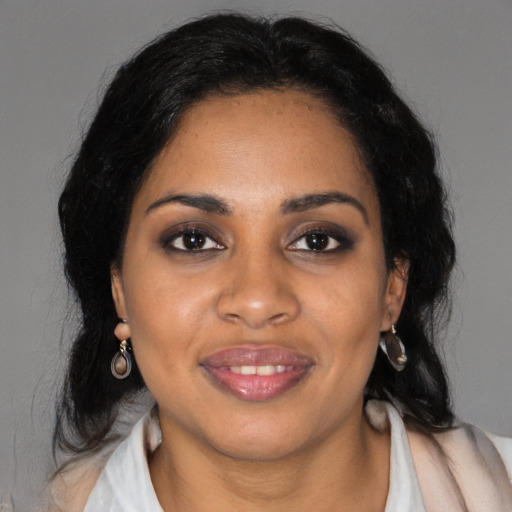Joyful black young-adult female with medium  black hair and brown eyes