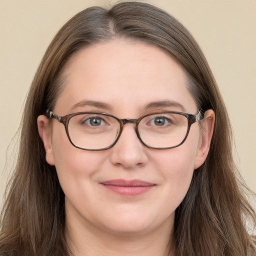 Joyful white adult female with long  brown hair and grey eyes