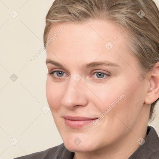 Joyful white young-adult female with medium  brown hair and blue eyes