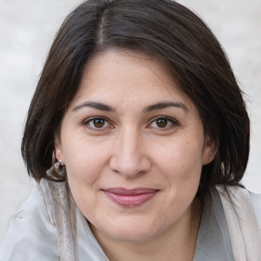 Joyful white adult female with medium  brown hair and brown eyes