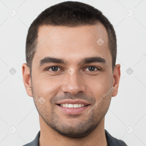 Joyful white young-adult male with short  brown hair and brown eyes