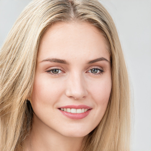 Joyful white young-adult female with long  brown hair and green eyes