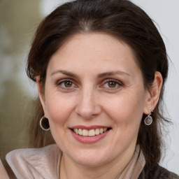 Joyful white adult female with medium  brown hair and grey eyes