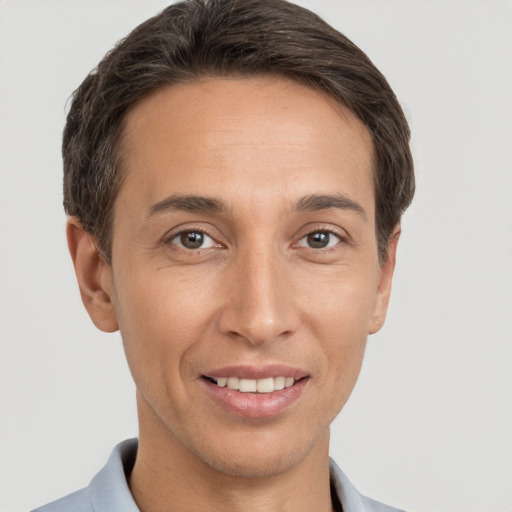 Joyful white adult male with short  brown hair and brown eyes