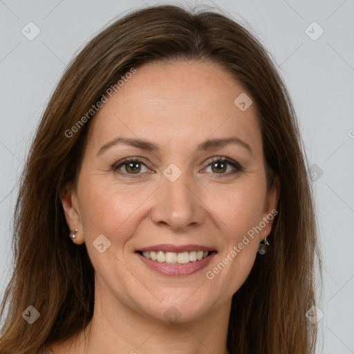 Joyful white adult female with long  brown hair and grey eyes