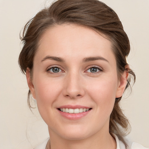 Joyful white young-adult female with medium  brown hair and blue eyes