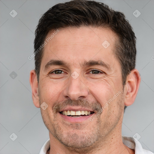 Joyful white adult male with short  brown hair and brown eyes