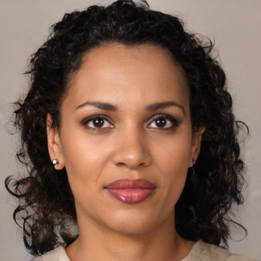 Joyful black young-adult female with medium  brown hair and brown eyes