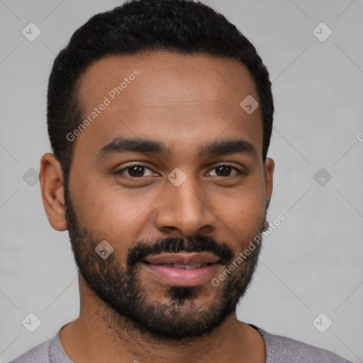 Joyful black young-adult male with short  black hair and brown eyes