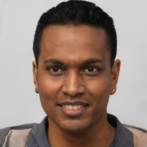 Joyful black young-adult male with short  black hair and brown eyes
