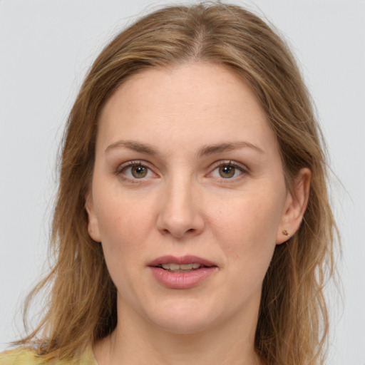 Joyful white adult female with long  brown hair and brown eyes