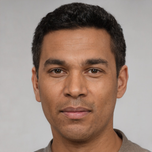 Joyful white young-adult male with short  black hair and brown eyes