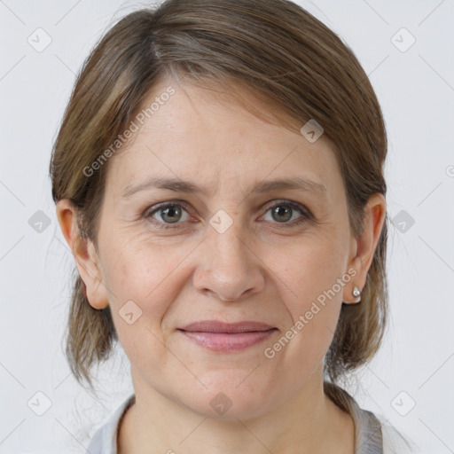 Joyful white adult female with medium  brown hair and grey eyes