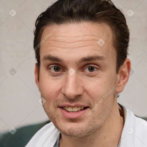 Joyful white adult male with short  brown hair and brown eyes