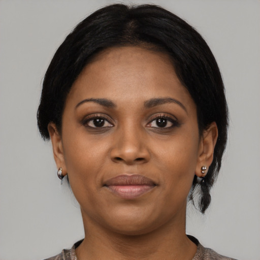 Joyful black young-adult female with medium  black hair and brown eyes