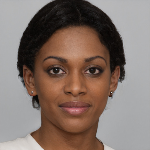 Joyful black young-adult female with short  brown hair and brown eyes