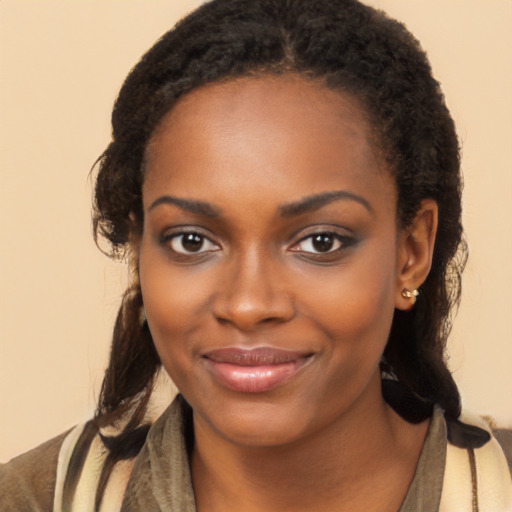 Joyful black young-adult female with long  brown hair and brown eyes