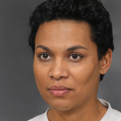 Joyful black young-adult female with short  brown hair and brown eyes