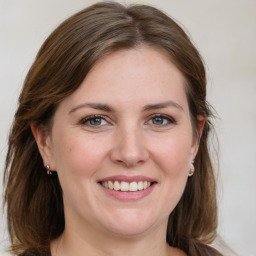 Joyful white young-adult female with medium  brown hair and blue eyes