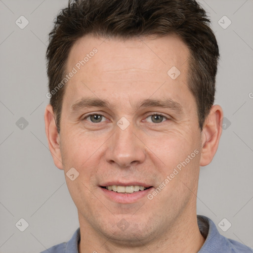 Joyful white adult male with short  brown hair and brown eyes