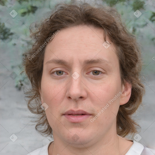 Joyful white adult female with medium  brown hair and blue eyes