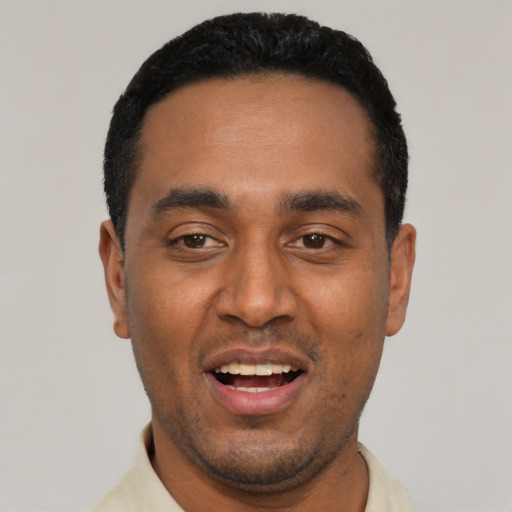 Joyful black young-adult male with short  black hair and brown eyes