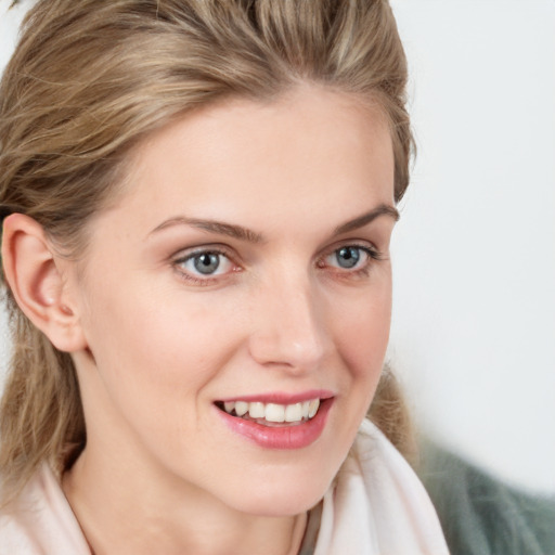 Joyful white young-adult female with medium  brown hair and blue eyes