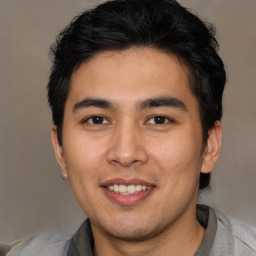 Joyful asian young-adult male with short  black hair and brown eyes