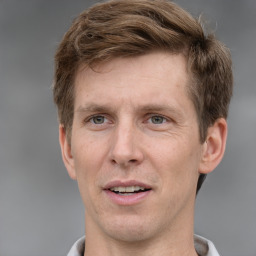 Joyful white adult male with short  brown hair and grey eyes