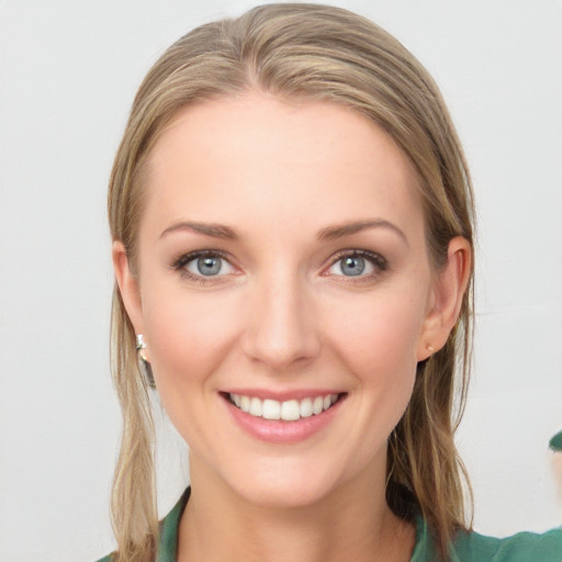 Joyful white young-adult female with medium  brown hair and blue eyes