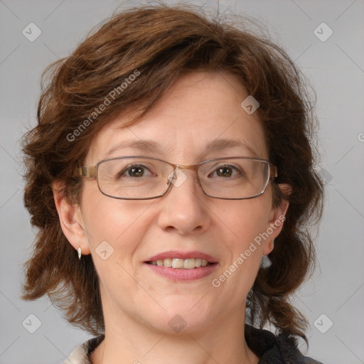 Joyful white adult female with medium  brown hair and blue eyes