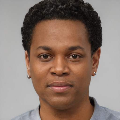 Joyful black young-adult male with short  black hair and brown eyes