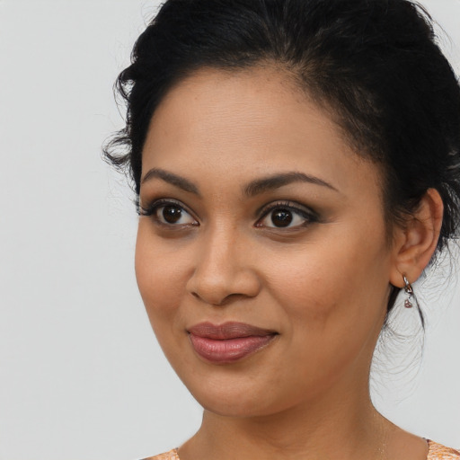 Joyful latino young-adult female with medium  black hair and brown eyes