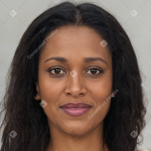 Joyful black young-adult female with long  brown hair and brown eyes