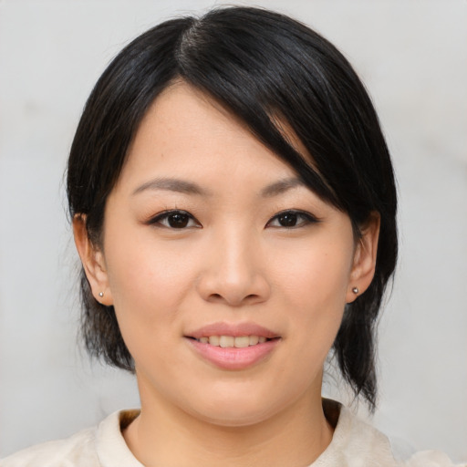 Joyful asian young-adult female with medium  black hair and brown eyes