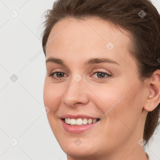 Joyful white young-adult female with medium  brown hair and grey eyes