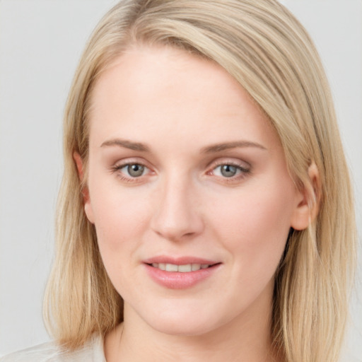 Joyful white young-adult female with medium  brown hair and blue eyes