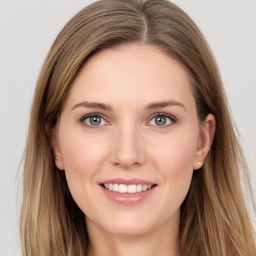 Joyful white young-adult female with long  brown hair and grey eyes