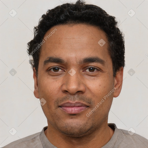 Neutral latino adult male with short  black hair and brown eyes