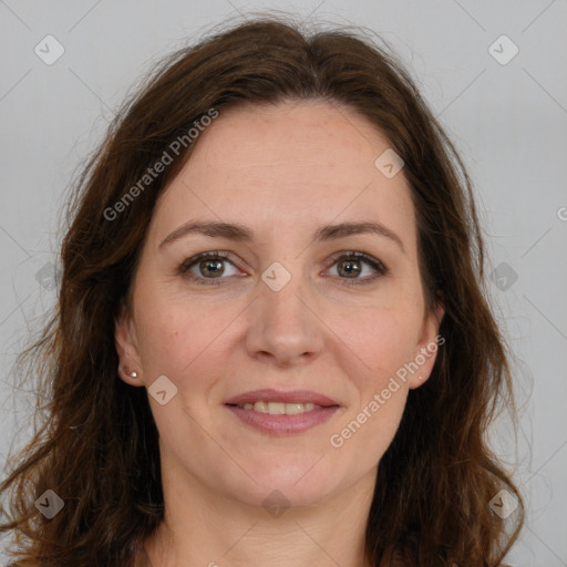 Joyful white adult female with long  brown hair and brown eyes