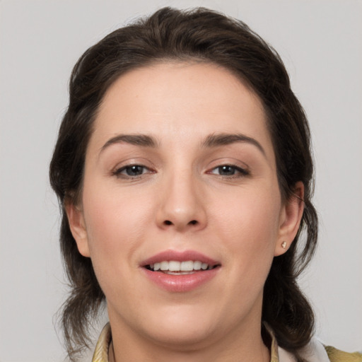 Joyful white young-adult female with medium  brown hair and brown eyes