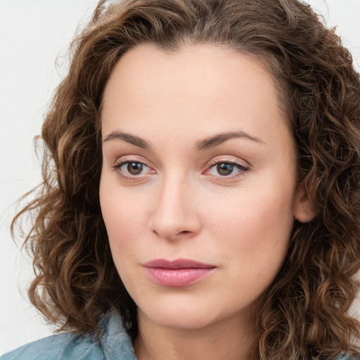 Joyful white young-adult female with long  brown hair and green eyes