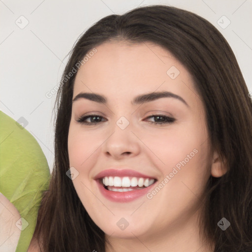 Joyful white young-adult female with long  brown hair and brown eyes