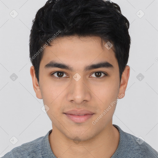 Joyful latino young-adult male with short  black hair and brown eyes