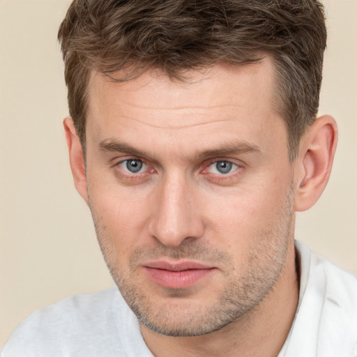 Joyful white adult male with short  brown hair and brown eyes