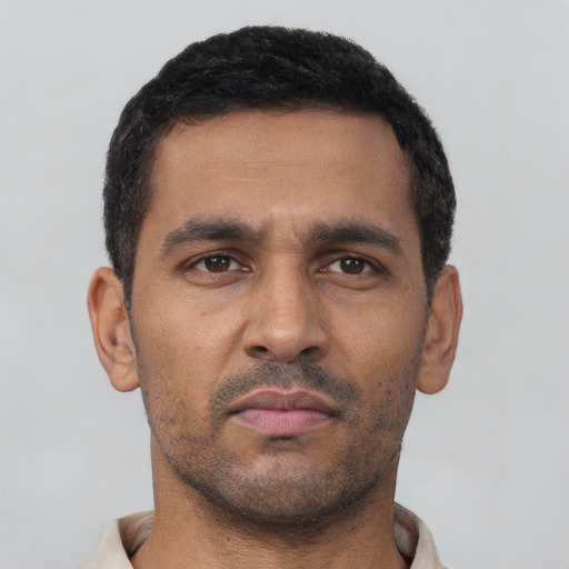 Neutral latino young-adult male with short  black hair and brown eyes