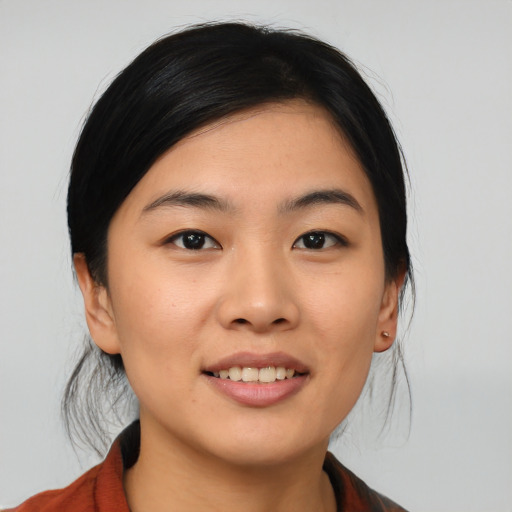 Joyful asian young-adult female with medium  black hair and brown eyes