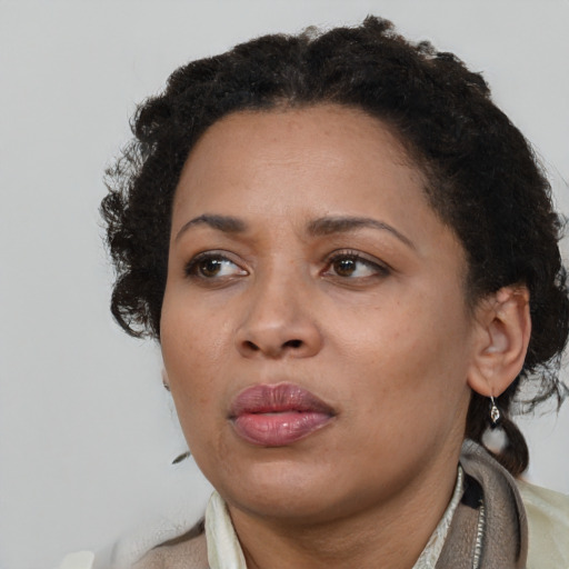Neutral black adult female with medium  brown hair and brown eyes
